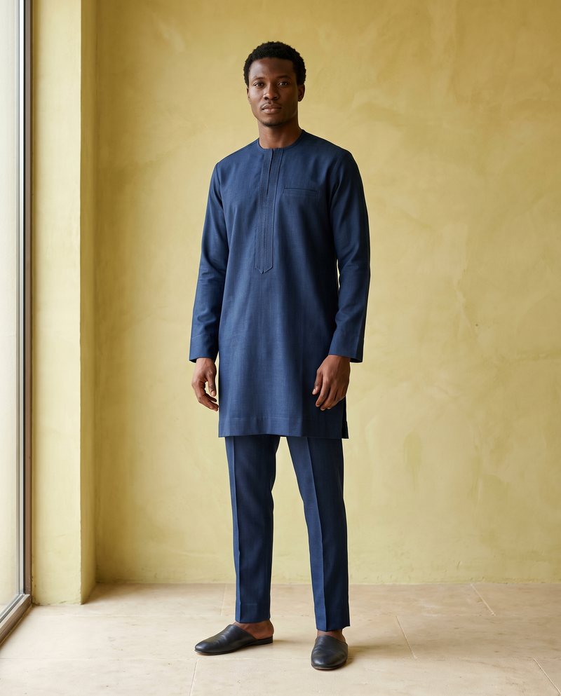 Indigo kaftan with matching trousers in a warm architectural studio